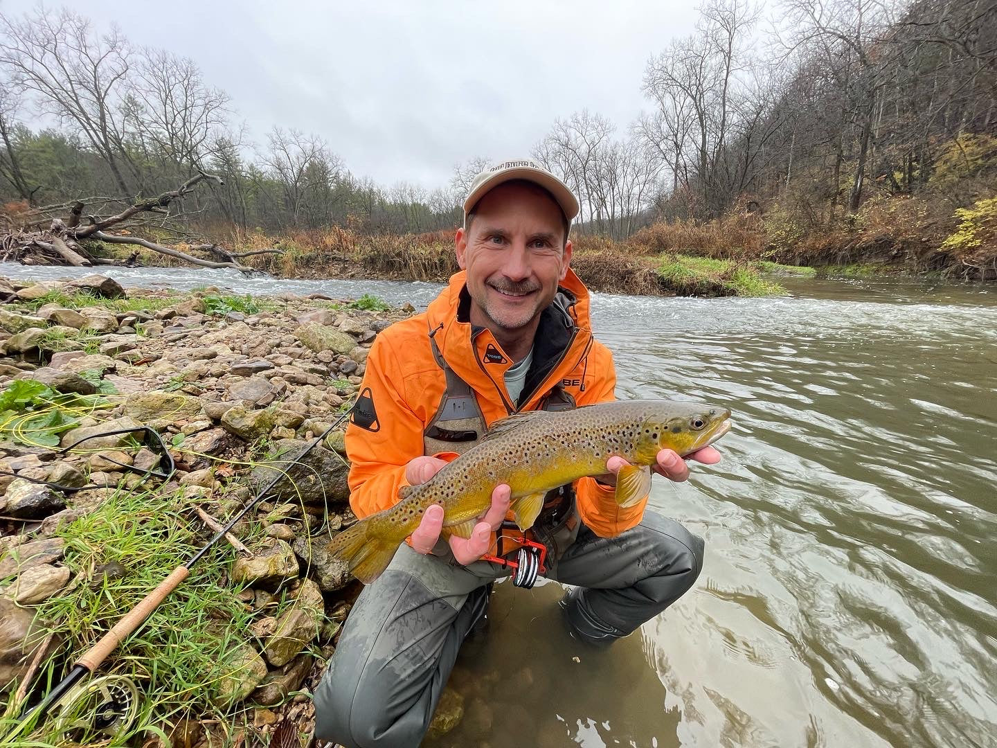 Image of a client holding a fish that they caught